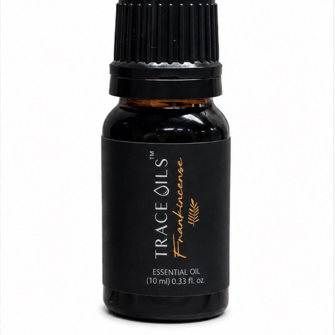 amber essential oil bottle with 'Trace Oils' branding on a white background and frankincense in gold lettering