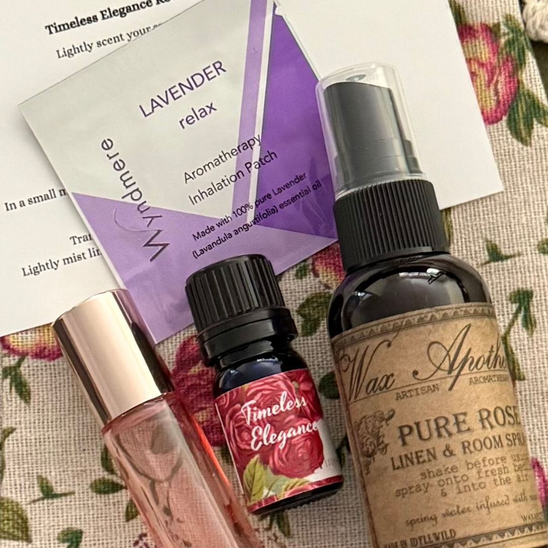 Aromatherapy products including a bottle of 'Pure Rose' linen and room spray, a small bottle labeled 'Timeless Elegance', and a lavender inhalation patch on a floral background.