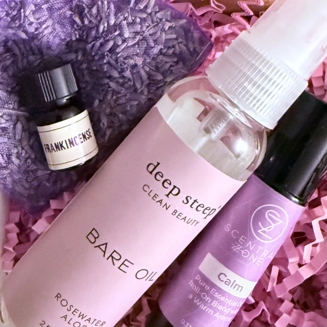 purple and pink gift box with calm oil franking oil and bare oil