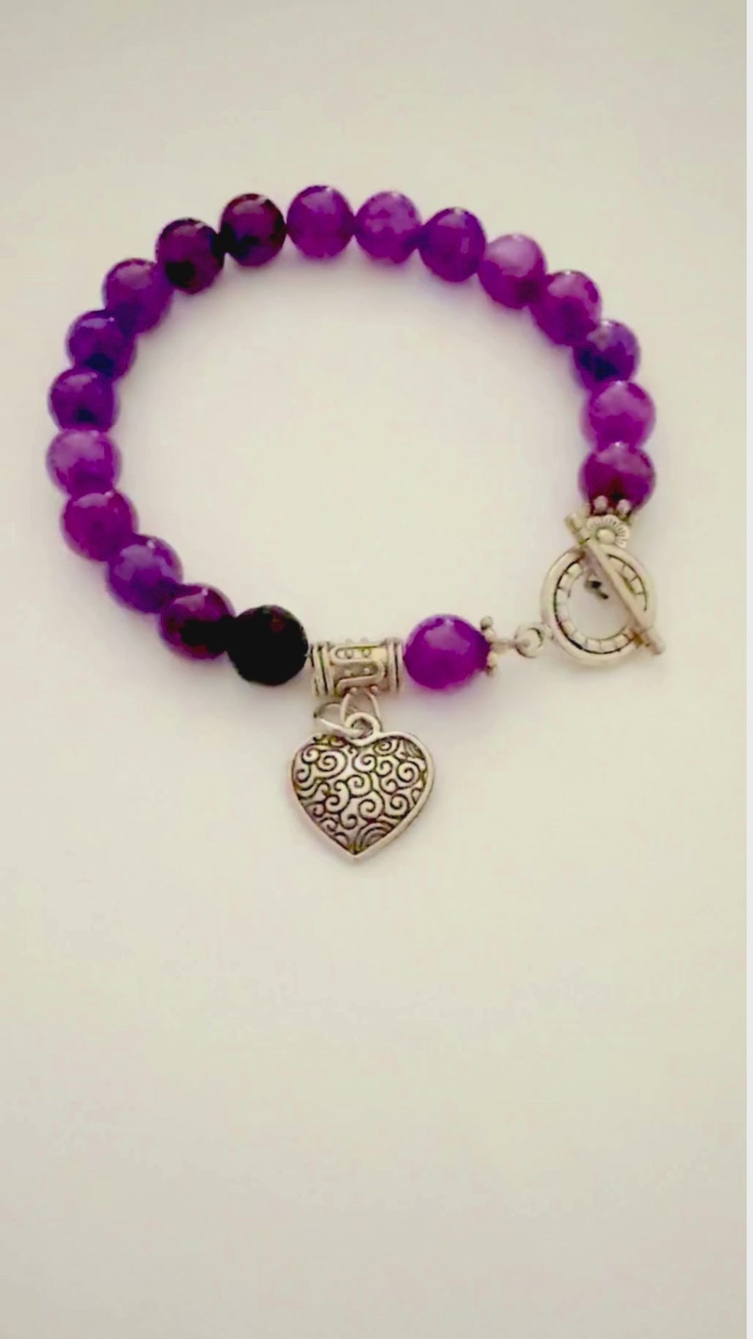 Video showing details of Amethyst essential oil diffuser bracelet with silver heart charm